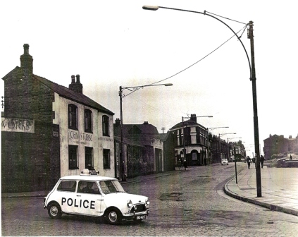 Unidentified Austin Mini Cooper S MkI in police service on a Liverpool street, with POLICE lettering and roof equipment.